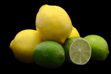 Lemons and limes isolated over black