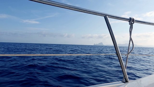 boat sailing in blue mediterranean sea on ibiza islands