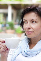 Young attractive woman, sitting in a cafe with a coffe