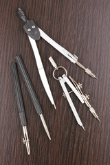 Drafting instruments on wooden background