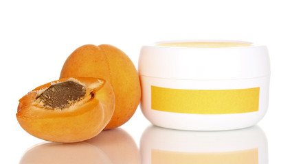 Jar of cream with juicy apricot isolated on white