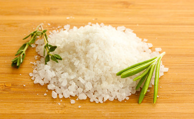 salt with fresh rosemary and and thyme on wooden background