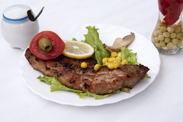 Appetizing juicy fried meat with green salad and  vegetables