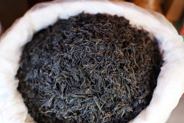 Black tea dried leaves selling in a bag on the market in India
