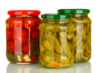 Jars of canned vegetables isolated on white