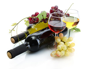 bottles and glasses of wine and ripe grapes isolated on white
