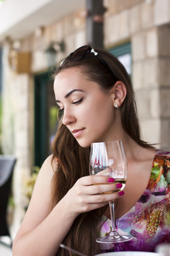 Woman drinking white wine in a restaurant