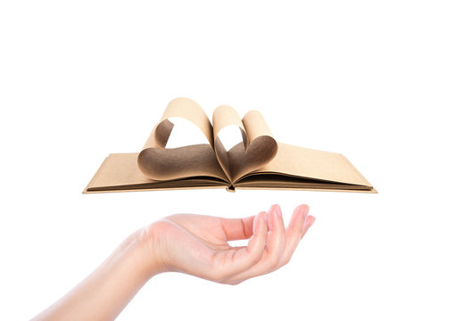 Beautiful woman  hand holding Book with opened pages of shape of