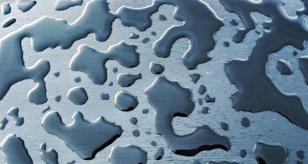 Fancifully shaped rain drops on wooden background