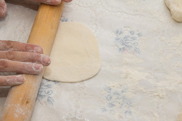 Flour in capacity with dough and rolling pin