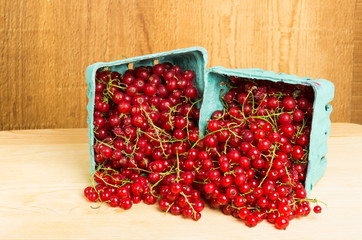 Red currants on wooden table