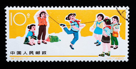 Stamp printed in China shows girls playing rubber band skipping