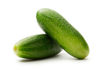 Fresh green cucumbers on white