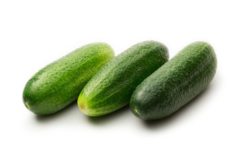 Fresh green cucumbers on white