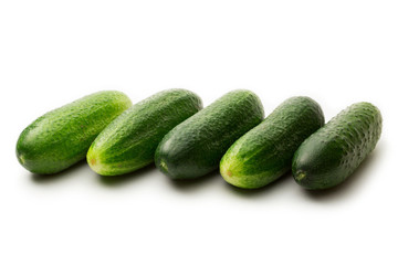 Fresh green cucumbers on white