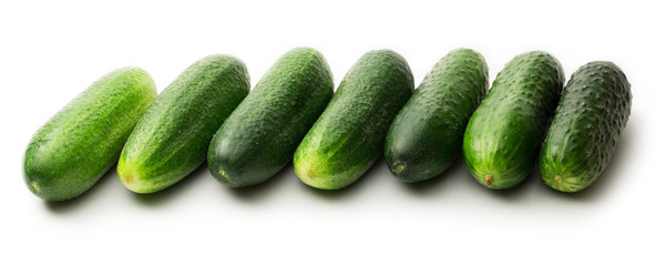 Fresh green cucumbers on white