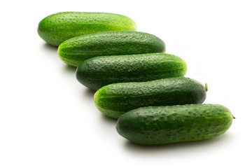 Fresh green cucumbers on white