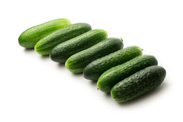 Fresh green cucumbers on white