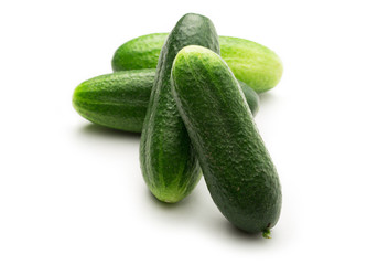Fresh green cucumbers on white