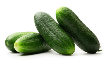 Fresh green cucumbers on white