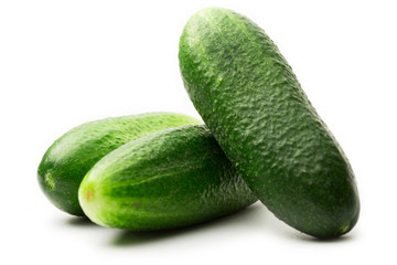 Fresh green cucumbers on white