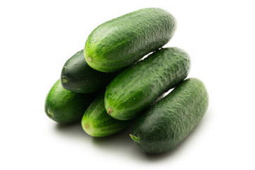Fresh green cucumbers on white