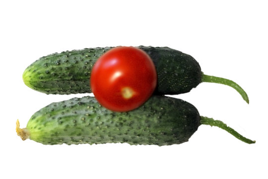 Red tomato and two cocumbers isolated on the white background
