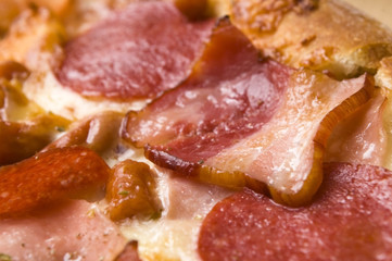 Italian pizza with bacon, salami and mozzarella cheese