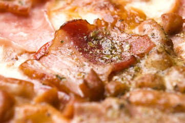 Italian pizza with bacon, salami and mozzarella cheese