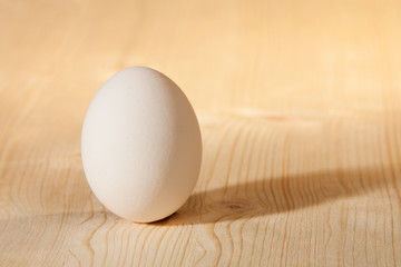 white egg on wooden table