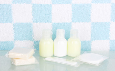 Hotel amenities kit on shelf in bathroom