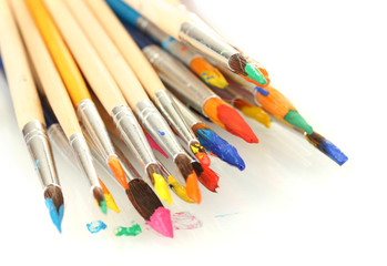 Paint brushes with gouache isolated on white