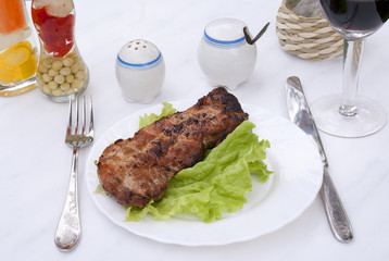 Appetizing juicy fried meat with green salad