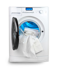 The washing machine with an open door and linen