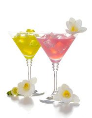 martini glasses of cocktails with ice and flowers isolated