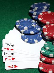 Cards and chips for poker on green table