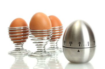 egg timer and egg in metal stand isolated on white