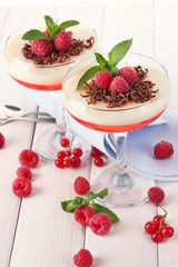 fruit jelly with berries in glasses on wooden table