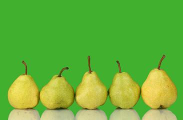 Ripe pears on bright green background