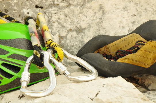 Detail of climbing helmet, carabiner and shoes
