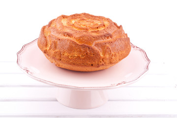 vanilla cake on a stand on a white background