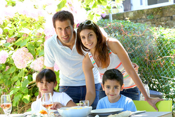 Closeup of happy family having lunch in garden
