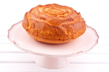 vanilla cake on a stand on a white background
