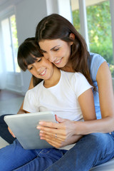 Fototapeta premium Mother and daughter websurfing on internet with tablet