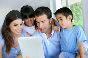 Fototapeta premium Parents and children using electronic tablet at home