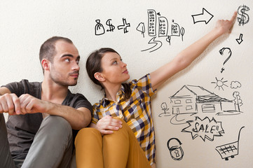 Closeup portrait of adult couple sitting on floor at their apart