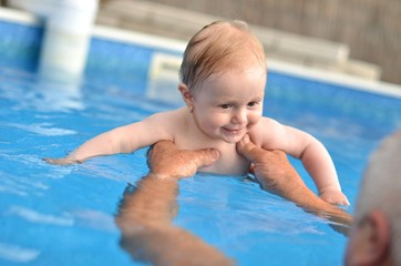Fototapeta na wymiar baby swimming in pool