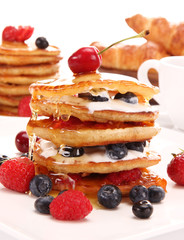 Small pancakes topped with honey 