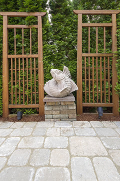 Asian Koi Fish Sculpture In Garden Backyard