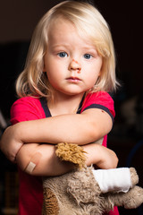 Injured little boy with adhesive bandage on elbow